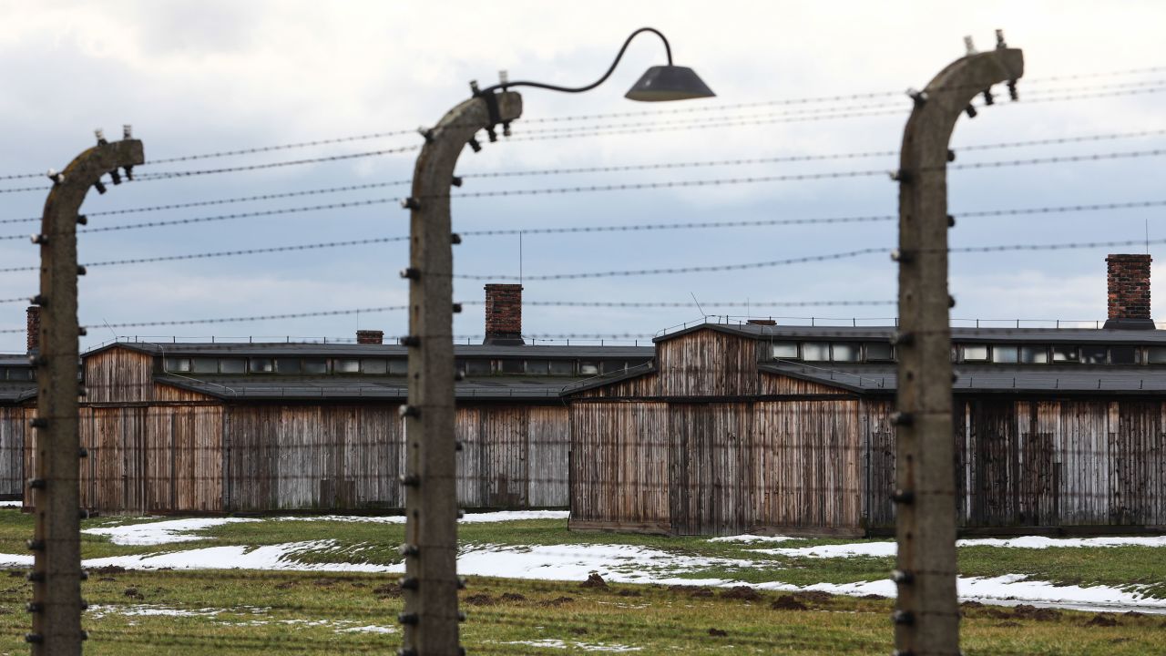 Barbed wires and camp barracks at former Nazi German concentration camp Auschwitz-Birkenau on January 23, 2021.