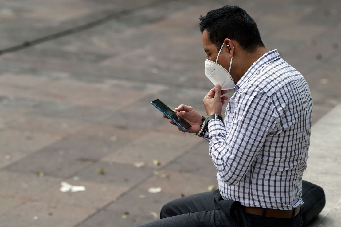 A man checks his phone Monday in Mexico City -- the day Facebook and its Instagram and WhatsApp platforms were hit by a massive outage.