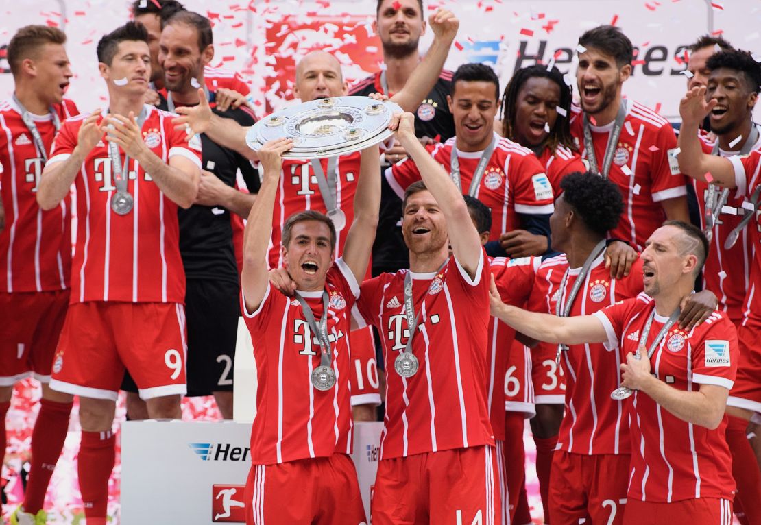Philipp Lahm and Xabi Alonso celebrate winning the Bundesliga in May 2017.