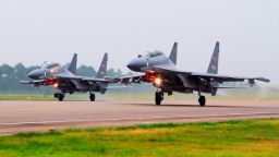 FILE - In this undated file photo released by China's Xinhua News Agency, two Chinese SU-30 fighter jets take off from an unspecified location to fly a patrol over the South China Sea. China flew more than 30 military planes, including SU-30 fighter jets, toward Taiwan on Saturday, Oct. 3, 2021, the second large display of force in as many days.(Jin Danhua/Xinhua via AP, File)