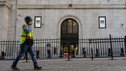 A construction worker walks past the New York Stock Exchange (NYSE) at Wall Street on Oct. 1, 2021 in New York City. 
