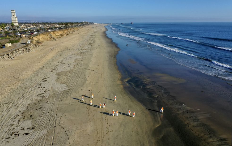 Environmental cleanup crews work in Huntington Beach on October 5.