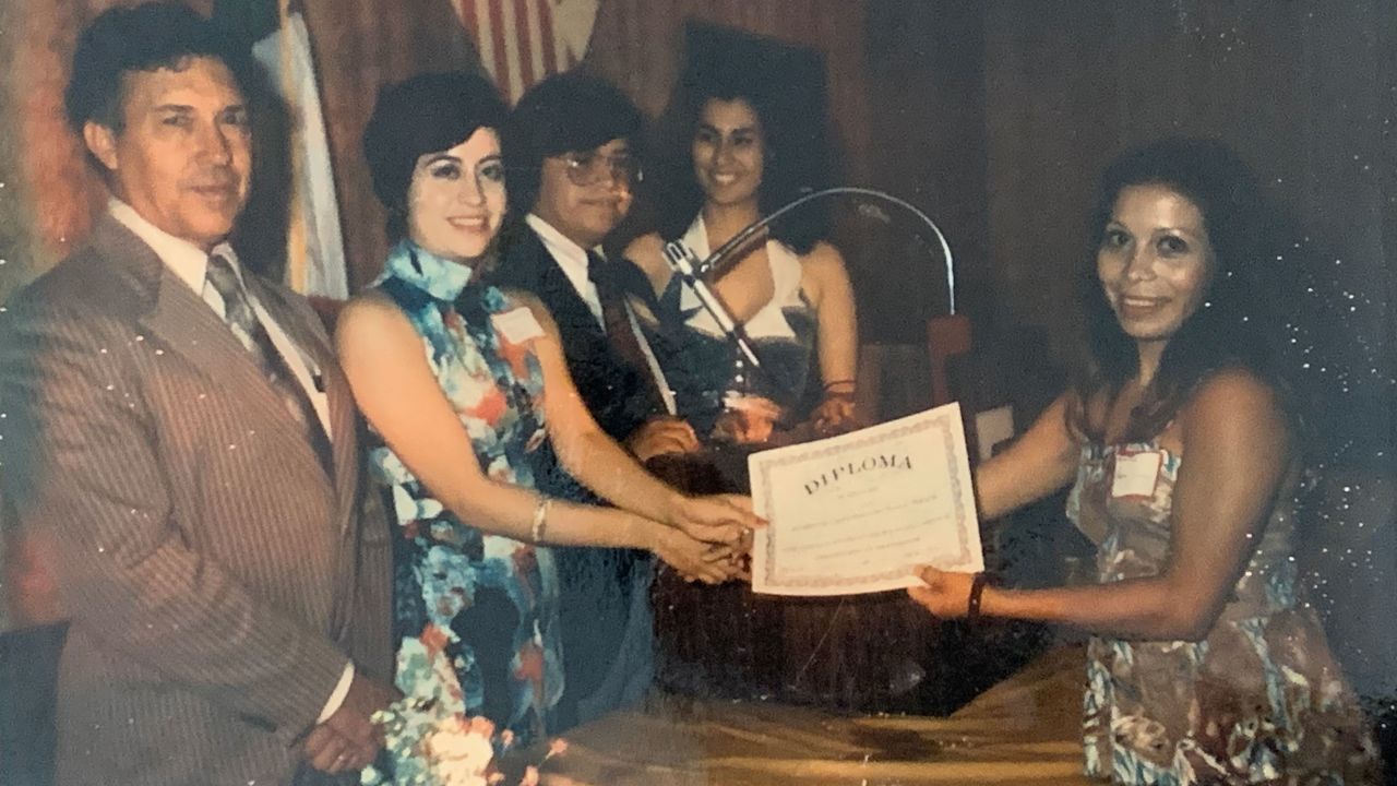 Rosie Jimenez receives her GED diploma during a ceremony in McAllen, Texas. This is an undated photo.