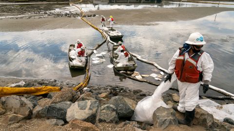 Workers with Patriot Environmental Services clean up some of the oil that flowed into the Talbert Marsh in Huntington Beach, California, on October 4.