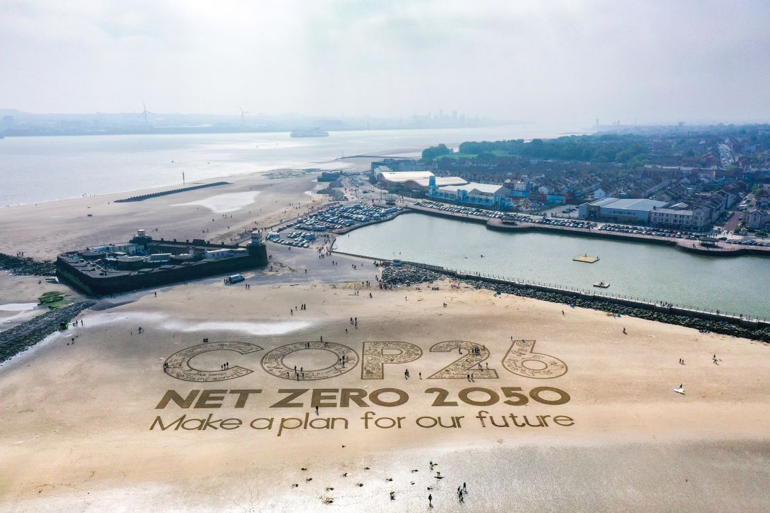 A giant sand artwork adorns New Brighton Beach on May 31, 2021 in Wirral, England, to highlight global warming and the COP26 climate conference.