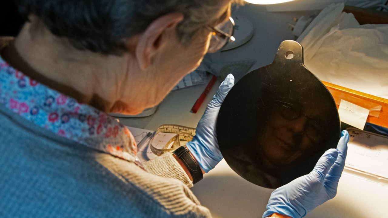 Researcher Elizabeth Healey holds John Dee's obsidian mirror.