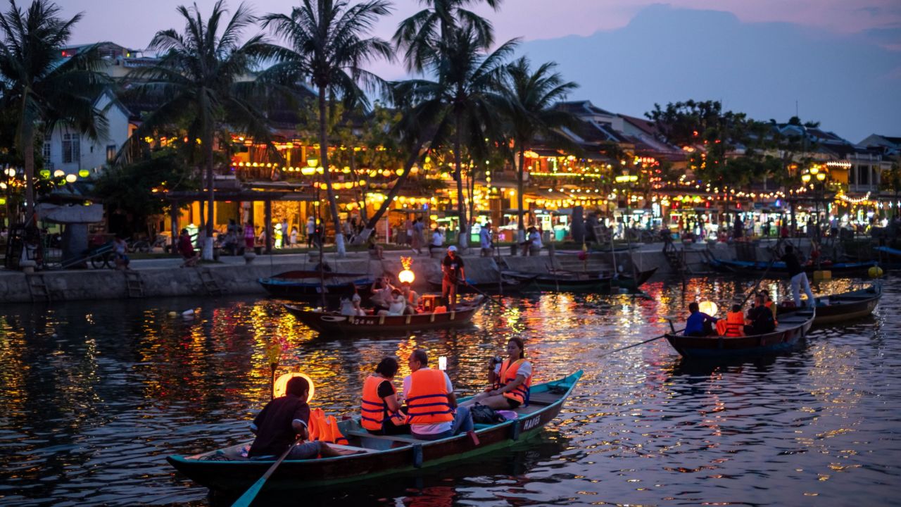 HOI AN, VIETNAM - APRIL 24: Tourists, mostly domestic, take a boat tour through Thu Bon river on April 24, 2021 in Hoi An, Vietnam. Hoi An, a UNESCO heritage site, once a hot spot favorited by foreign tourists, has had to undergo the tribulations of survival amid Covid-19 impacts. The number of domestic visitors has begun rising thanks to the effort of key players in the tourism sector by decreasing airfares, entrance fees and adding more tourism products that fit the domestic tourist market, such as opening pedestrian zones, night markets, craft villages and traditional games. (Photo by Linh Pham/Getty Images).