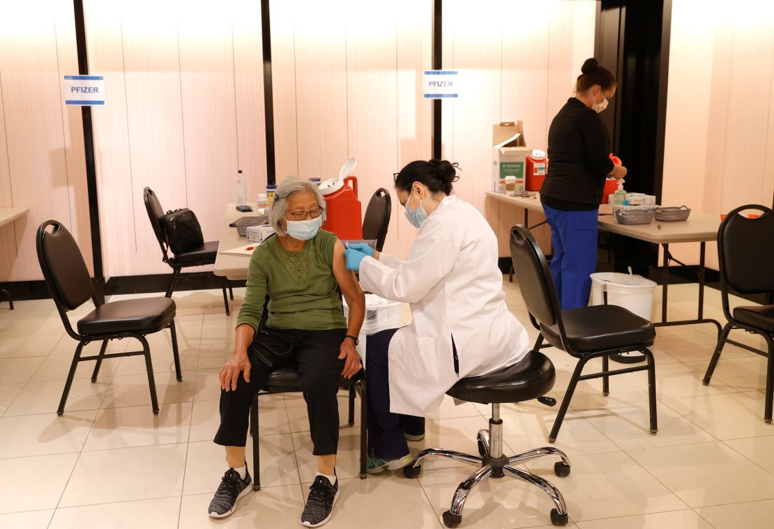 A Safeway pharmacist on prepares to give a Pfizer Covid-19 booster shot in San Rafael, California, on October 1.