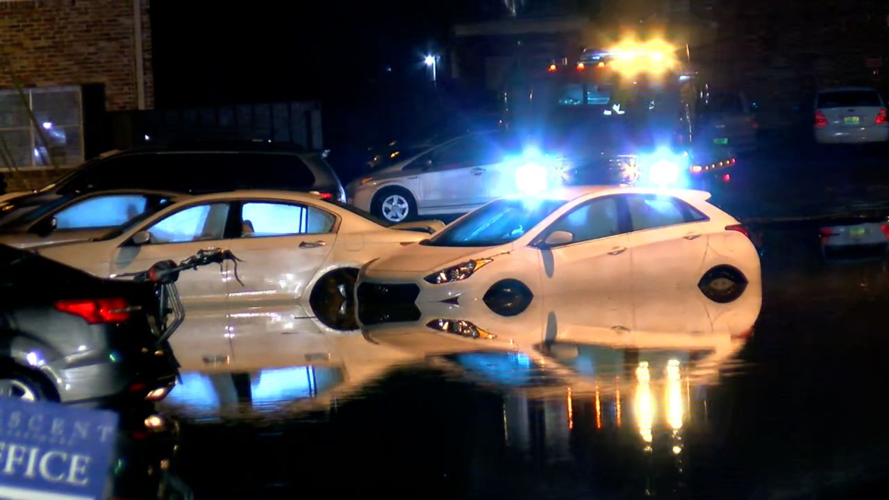 Water surrounds vehicles in a parking lot in Birmingham on Thursday morning.