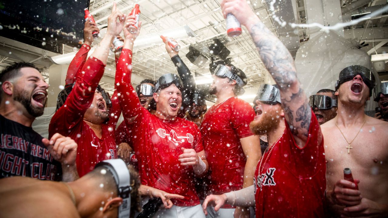 The Boston Red Sox celebrate with champagne in their clubhouse after winning the 2021 American League wild card game against the New York Yankees.