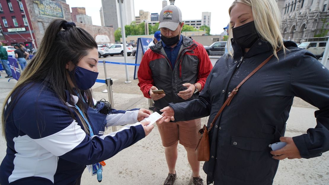 A security guard checks Covid-19 vaccination cards before a game between the Toronto Blue Jays and Miami Marlins on June 2, 2021.