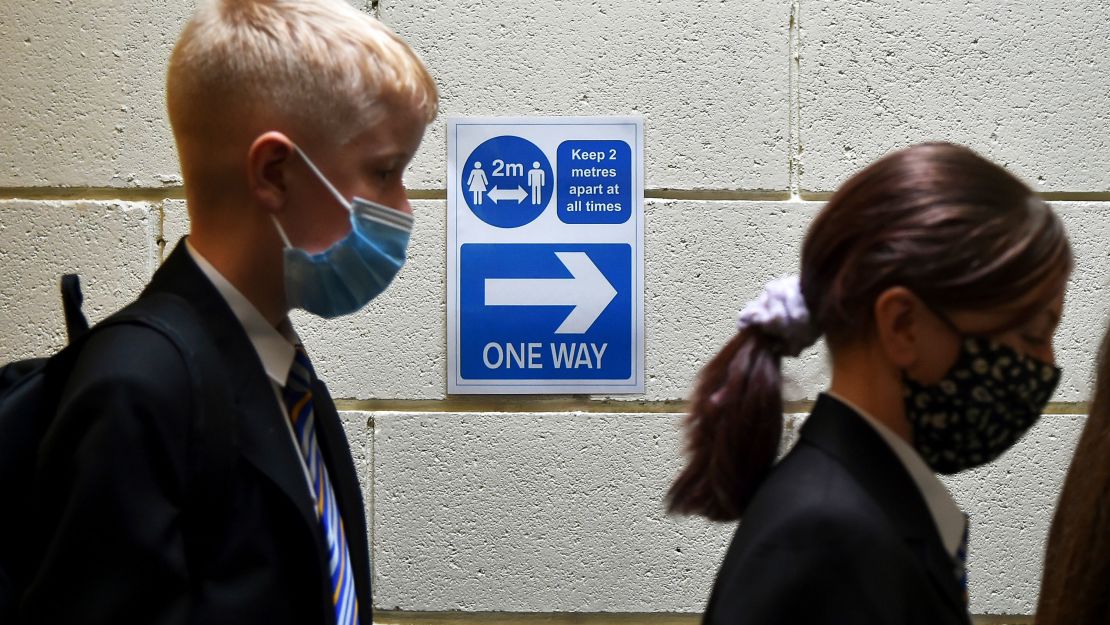 Secondary school students enter their school for the first time this year in Sheffield, England, on September 3.