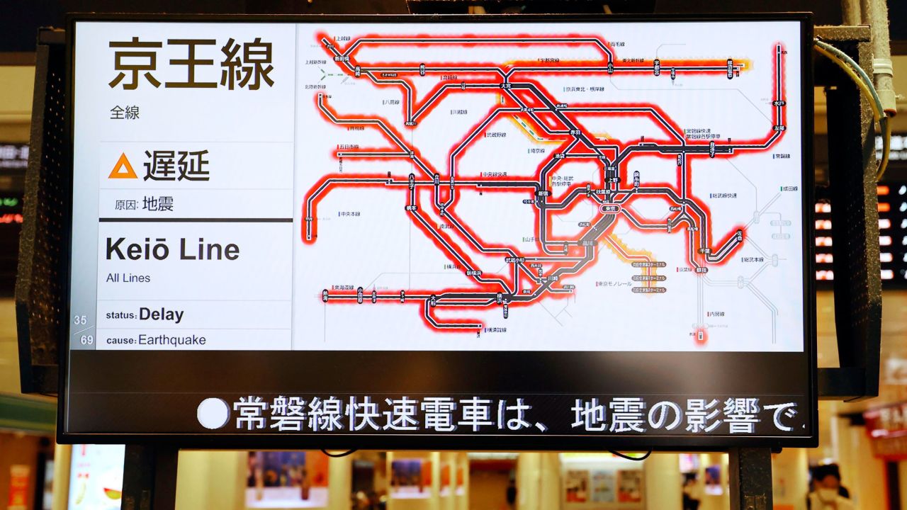 The status of the train services delayed by the earthquake are seen on a monitor at JR Tokyo station.