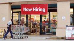 A Now Hiring sign hangs near the entrance to a Winn-Dixie Supermarket on September 21, 2021 in Hallandale, Florida.