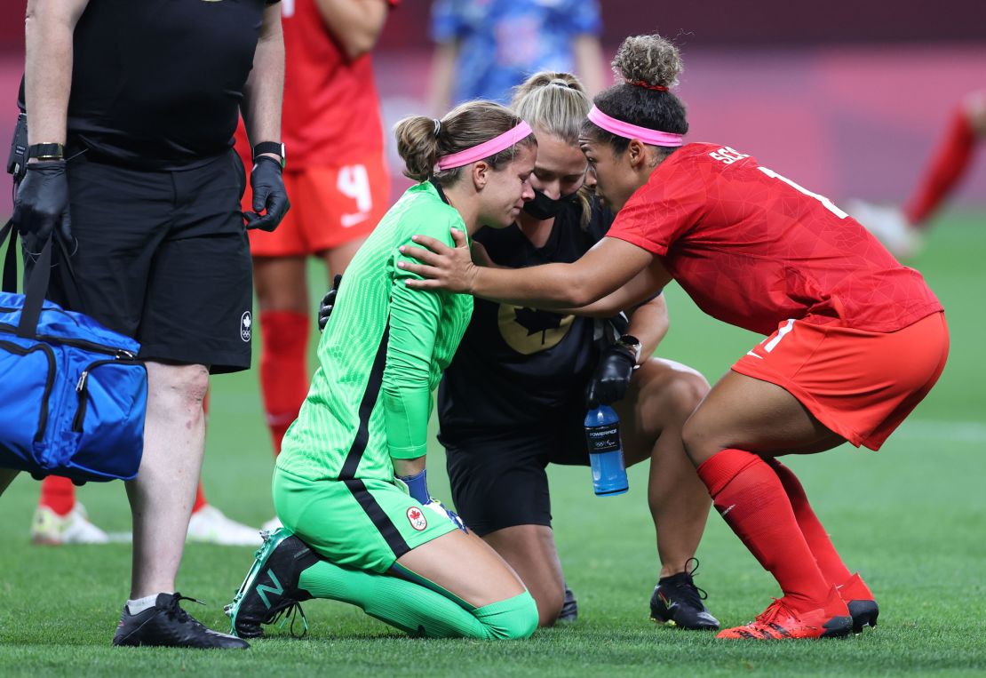 Labbe receives medical treatment during the match against Japan.