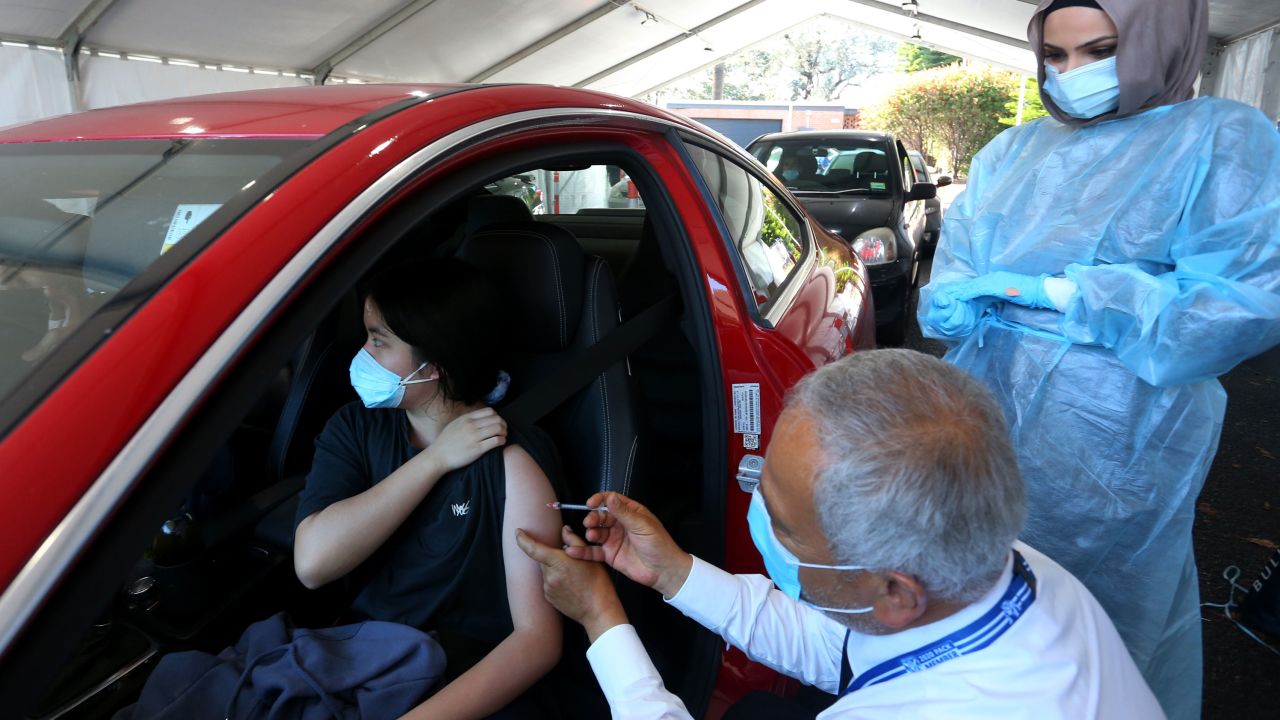 A doctor administers the Pfizer vaccine to a client at the Belmore Sports Ground vaccination hub on October 3 in Sydney, Australia.