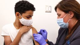 Clinical pharmacist Laura Gaar administers a COVID-19 vaccination dose to a 14-year-old at Lake Charles Memorial Hospital on August 10, 2021 in Lake Charles, Louisiana.