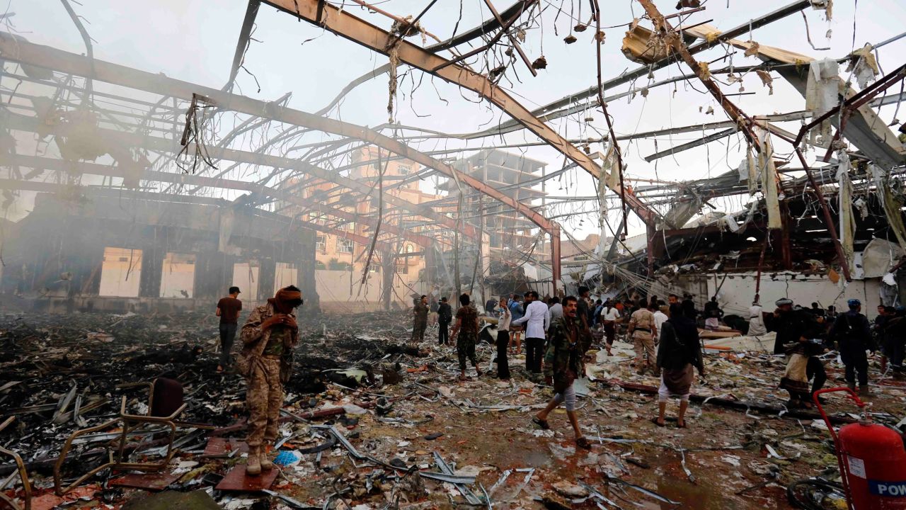 In this Oct. 8, 2016 file photo, people inspect the aftermath of a Saudi-led coalition airstrike in Sanaa, Yemen. 
