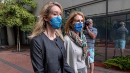Elizabeth Holmes, founder of Theranos Inc., left, exits federal court in San Jose, California, U.S., on Wednesday, Oct. 6, 2021. Holmes has pleaded not guilty but faces as long as 20 years in prison if convicted of fraud and conspiracy charges. 