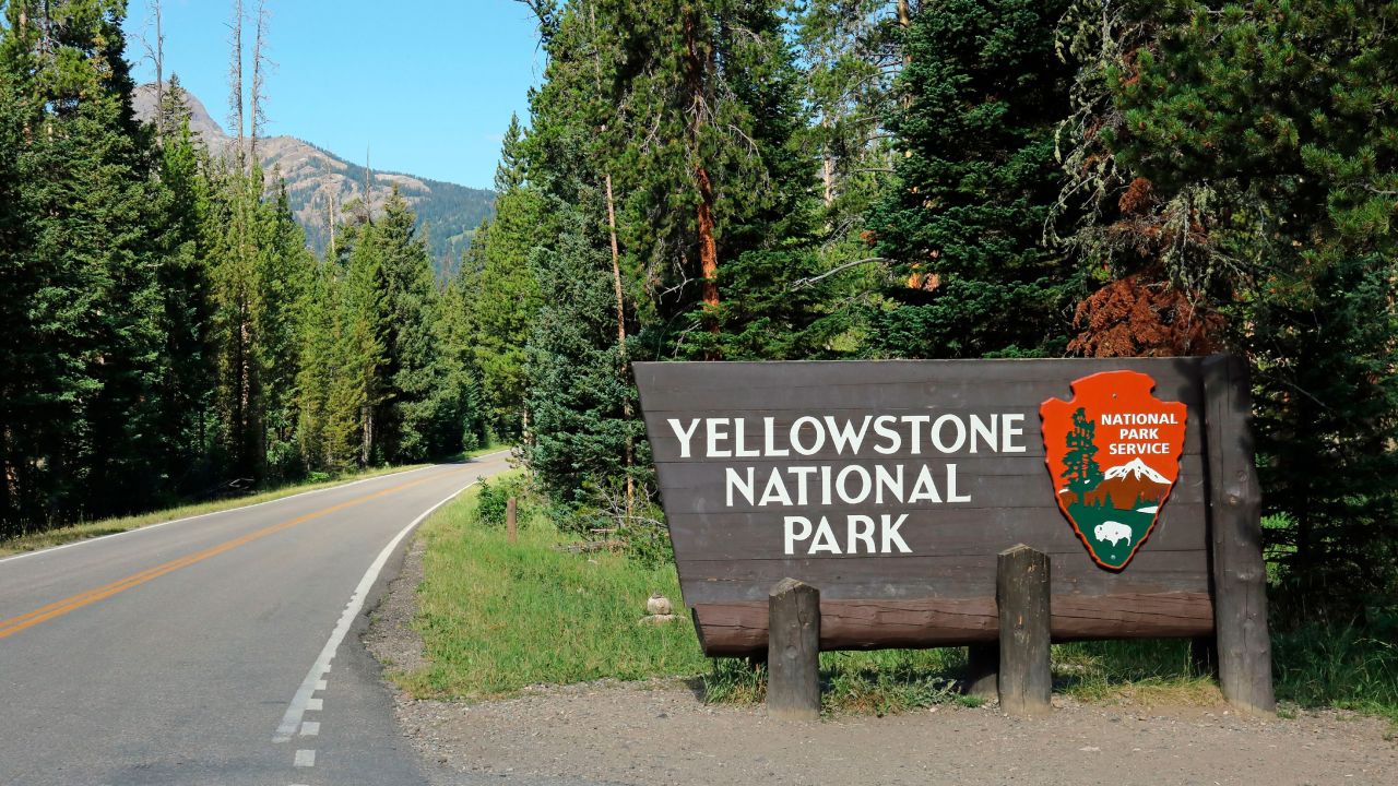 Entrance sign along U.S. Highway 212 at the northeast entrance into Yellowstone National Park in Wyoming, The northeast entrance to Yellowstone National Park is on US Highway 212 a few miles west of Cooke City Montana as one crosses into Wyoming. (Photo by: Education Images/Universal Images Group via Getty Images)