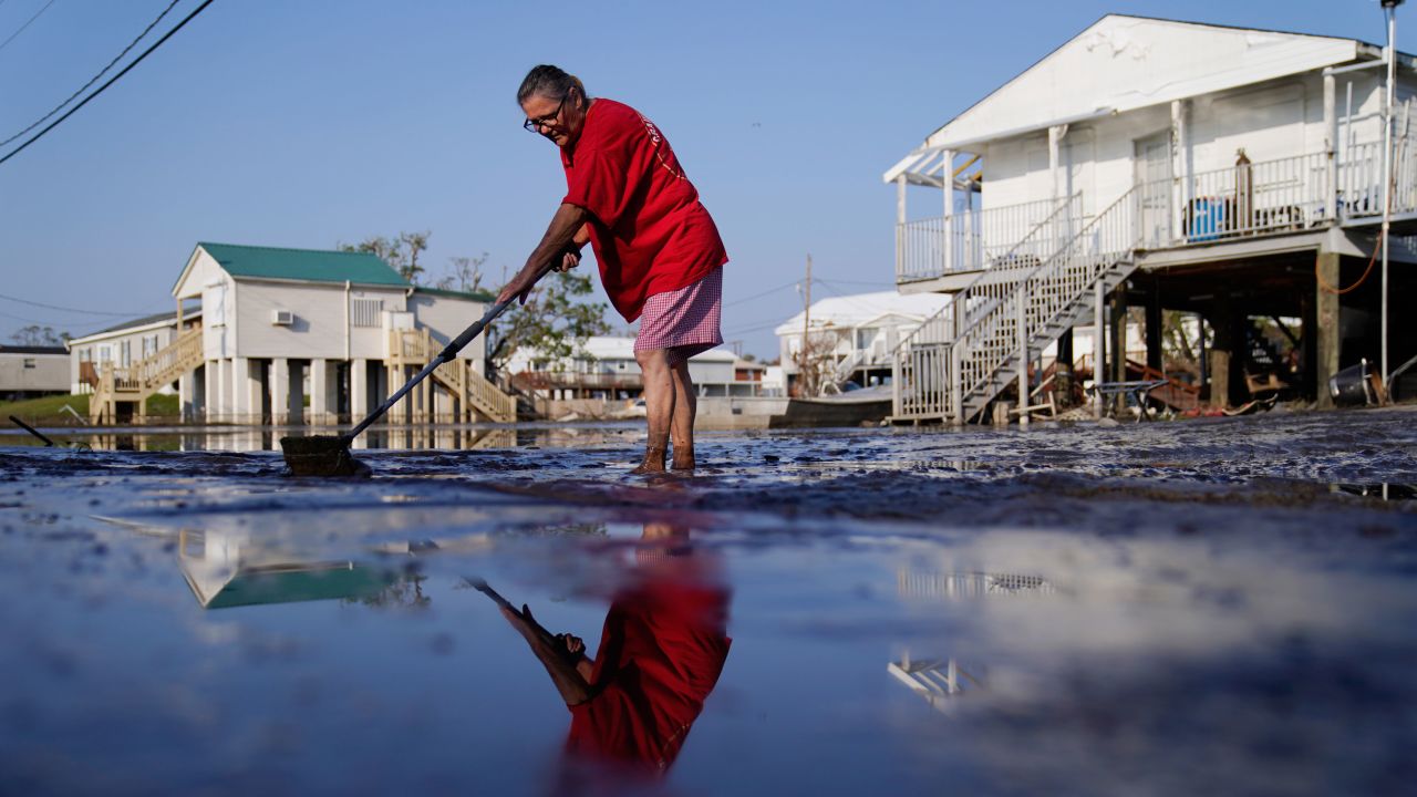 Cindy Rojas cleans mud and floodwater from her driveway in Lafitte, Louisiana, in the aftermath of Hurricane Ida in September.