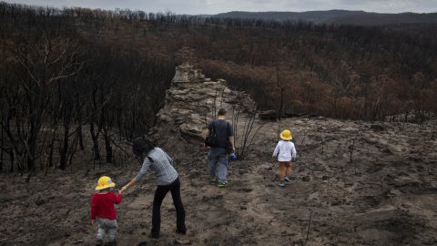 A family from Sydney, Australia, visiting an area devastated by bush fires in the New South Wales region of Australia on Jan. 28, 2020. 