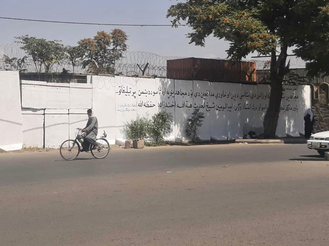Taliban paint over mural in Kabul and replace it with text that reads "don't trust the propaganda of the enemy".