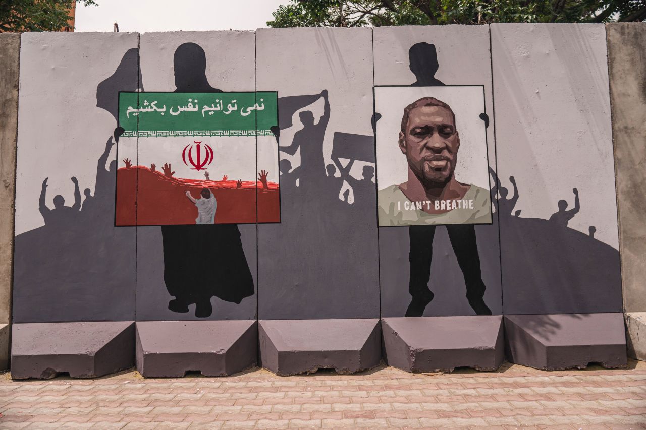 A mural honors the killing of George Floyd and Afghan refugees allegedly drowned in Iran reads "we can't breathe". 