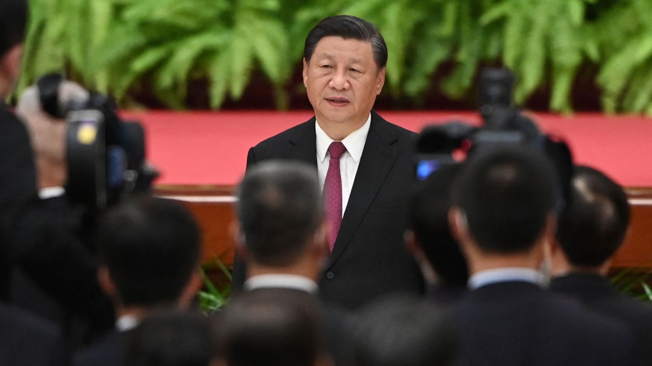 Chinese President Xi Jinping sings the national anthem during a reception at the Great Hall of the People on the eve of China's National Day in Beijing on September 30.