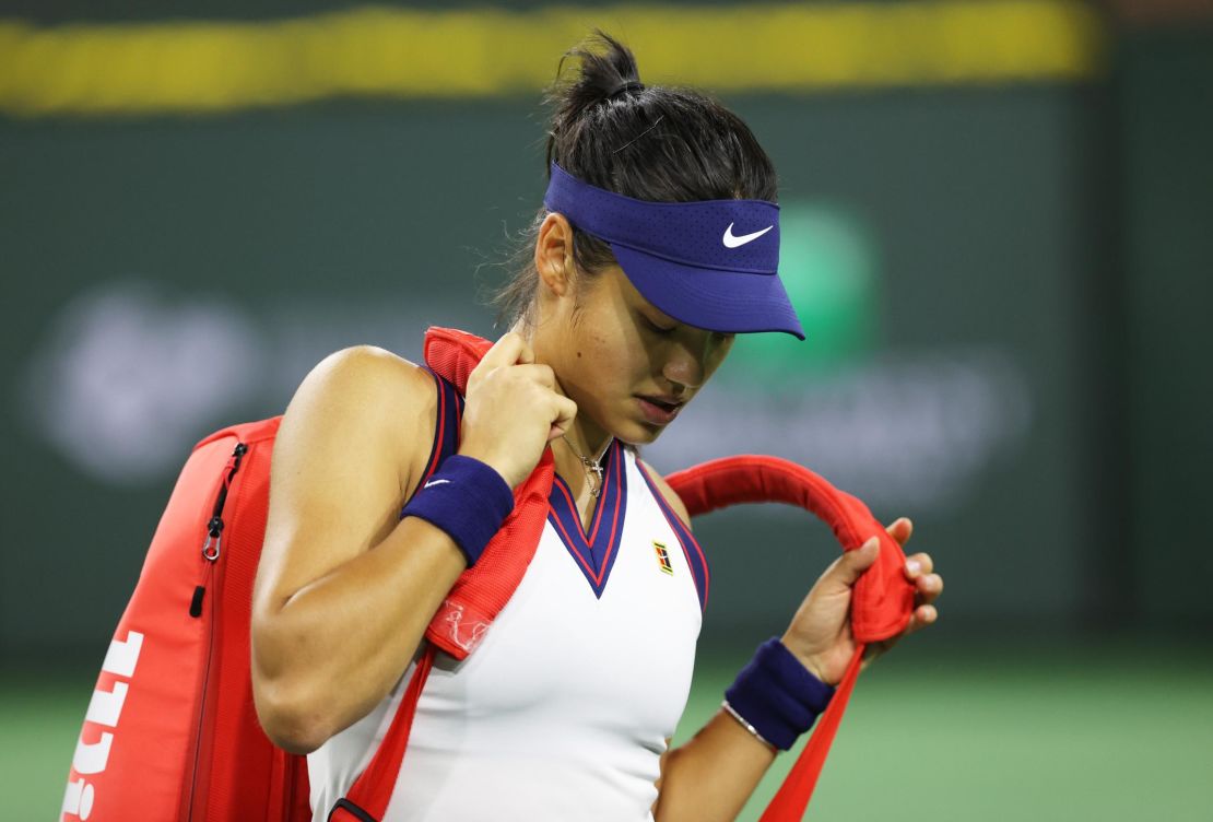 Emma Raducanu grabs her racket bag ready to walk off court after her straight sets defeat against Aliaksandra Sasnovich at the Indian Wells tournament.