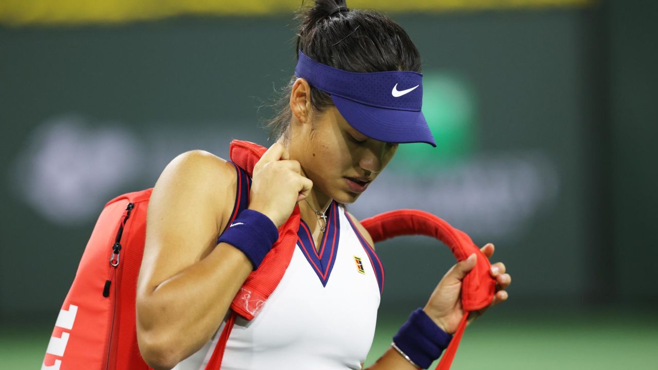 Emma Raducanu grabs her racket bag ready to walk off court after her straight sets defeat against Aliaksandra Sasnovich at the Indian Wells tournament.