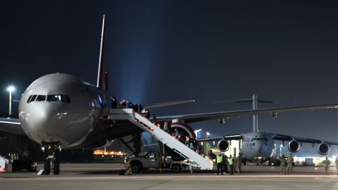 Evacuees board an outbound flight to the United States from Ramstein Air Base, Germany, on October 9, 2021. 