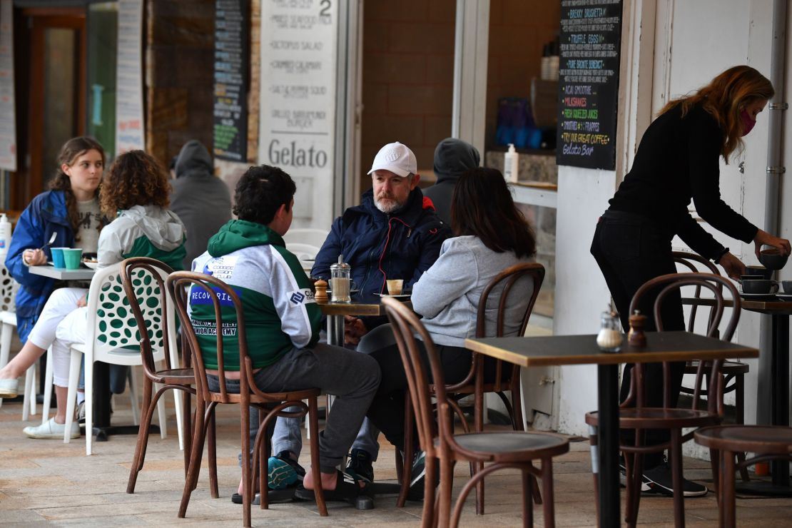 Diners sit at a cafe in Sydney, Australia on October 11 as the city emerges from lockdown.