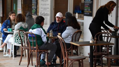 Diners sit at a cafe in Sydney, Australia on October 11 as the city emerges from lockdown.