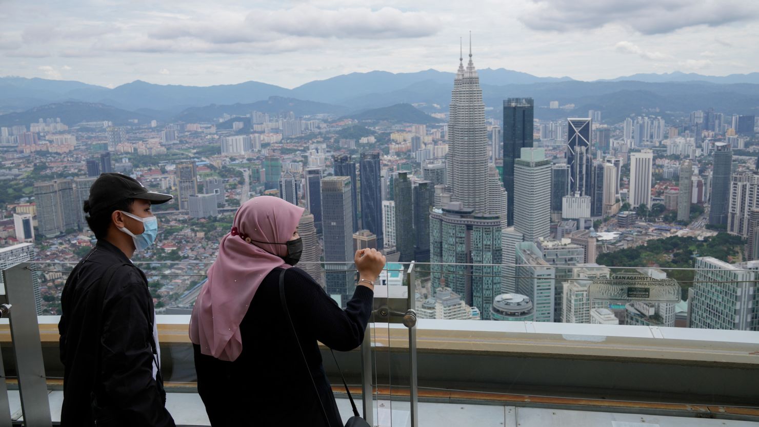 People wearing face masks take in the view from an observation deck at the Kuala Lumpur Tower in Malaysia on October 1.