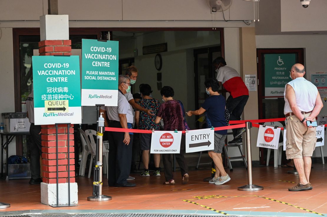 People enter a Covid-19 vaccination center in Singapore on October 7.