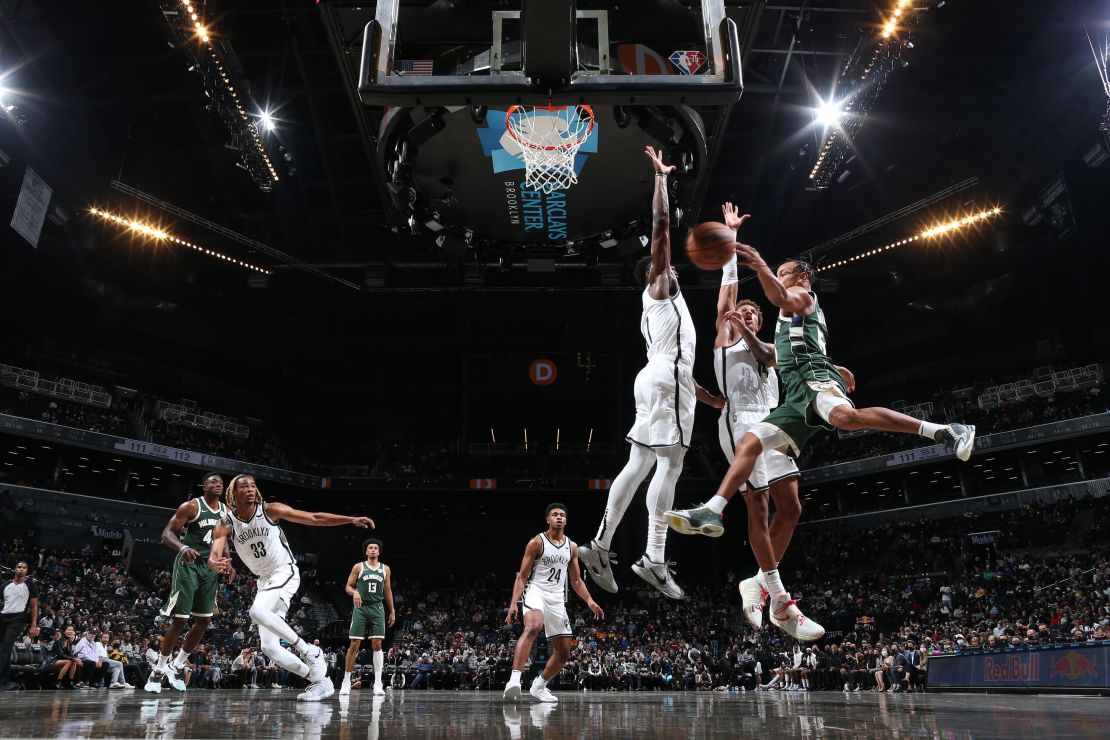 Justin Robinson of the Bucks drives to the basket during the preseason game against the Nets.