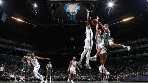 Justin Robinson of the Bucks drives to the basket during the preseason game against the Nets.