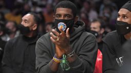 Kyrie Irving #11 of the Brooklyn Nets cheers from the bench during a preseason game against the Los Angeles Lakers at Staples Center on Oct. 3, 2021 in Los Angeles.