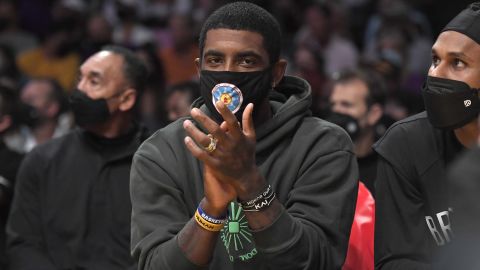 Kyrie Irving cheers from the bench during a preseason game against the Los Angeles Lakers on Oct. 3 in Los Angeles.