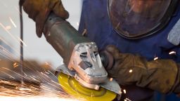 Sparks are seen as a man uses an angle grinder to cut and polish steel in a factory on June 5, 2017 in Cardiff, United Kingdom. 