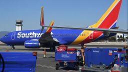 A Southwest Airlines baggage handler loads luggage on the tarmac at Hollywood Burbank Airport in Burbank, California, October 10, 2021.