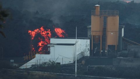 Lava rolls down behind the cement factory on Monday as the Cumbre Vieja volcano continues to erupt on the Canary Island of La Palma.