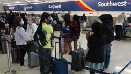 Passengers wait in line at the Southwest Airlines ticket counter at Fort Lauderdale Hollywood International Airport, Monday, Oct. 11, 2021. The Dallas-based airline canceled hundreds of flights Monday following a weekend of major service disruptions. 