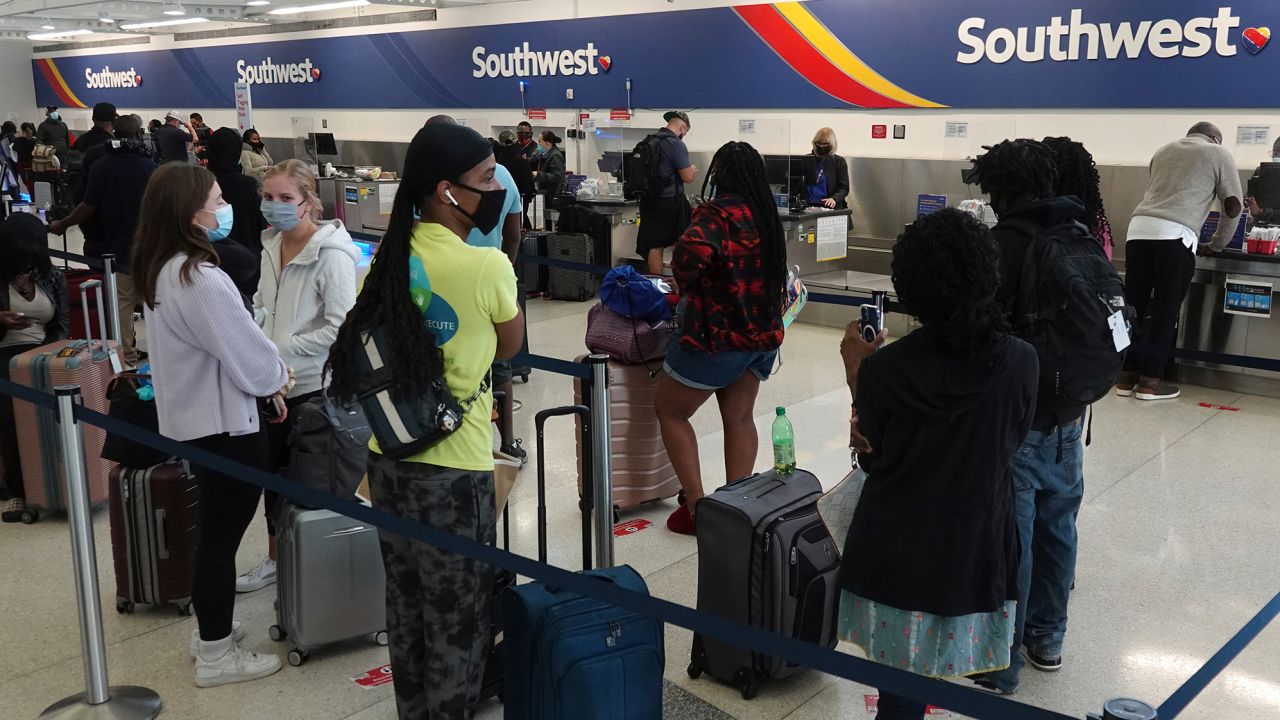 Passengers wait in line at the Southwest Airlines ticket counter at Fort Lauderdale Hollywood International Airport on October 11. 