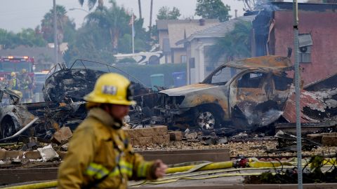 Fire crews searched the scorched damage after the plane crash into the neighborhood.