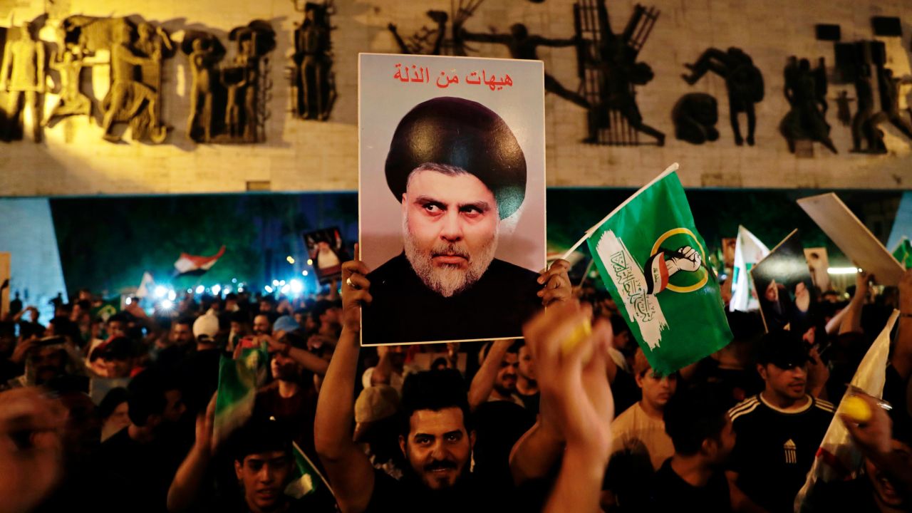 Followers of Shia cleric Muqtada al-Sadr celebrate holding his posters, after the announcement of the results of the parliamentary elections in Tahrir Square, Baghdad, Iraq, Monday, Oct. 11, 2021.