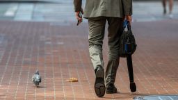 A pedestrian walks on Market Street in San Francisco, California, U.S., on Tuesday, Oct. 5, 2021. 