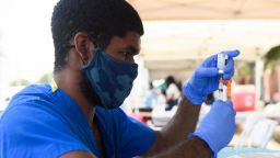 A health care worker prepares a dose of the Moderna Covid-19 vaccine during a Kedren Health mobile vaccine clinic at the Watts Juneteenth Street Fair on June 19, 2021 in the Watts neighborhood of Los Angeles, California. - The US on June 17 designated Juneteenth, which marks the end of slavery in the country, a federal holiday with President Joe Biden urging Americans "to learn from our history." (Photo by Patrick T. FALLON / AFP) (Photo by PATRICK T. FALLON/AFP via Getty Images)