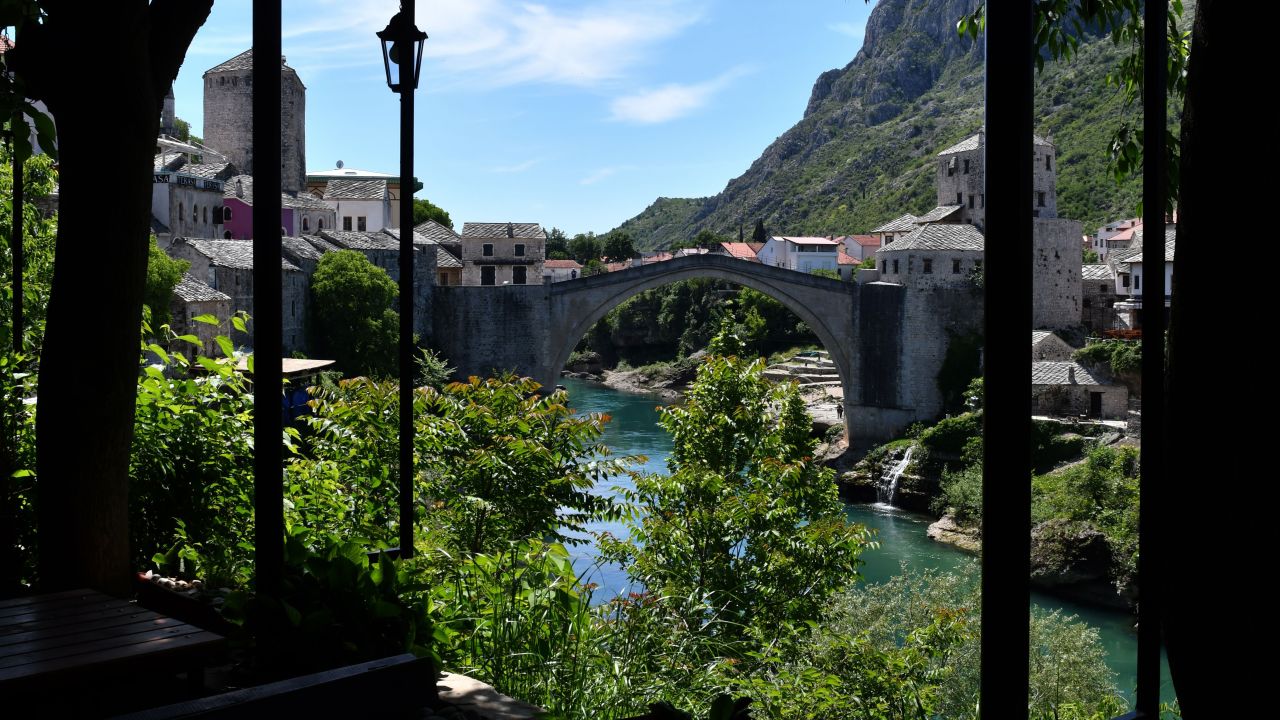 TOPSHOT - The deserted "Old Bridge" of Mostar, usually riddled with groups of tourists is seen from an empty restaurant terrace, on May 8, 2020. - With more than 90 percent of those tourists foreigners, the town is now facing a particularly painful collapse as the COVID-19 pandemic caused by the novel coronavirus, shutters international borders and severely curbs air travel, sending the global tourism industry into a tailspin. (Photo by ELVIS BARUKCIC / AFP) (Photo by ELVIS BARUKCIC/AFP via Getty Images)